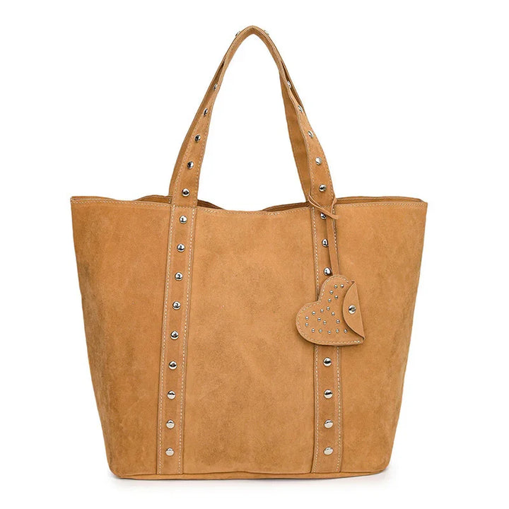 tan suede tote bag with studded handles and heart-shaped studded accessory purse