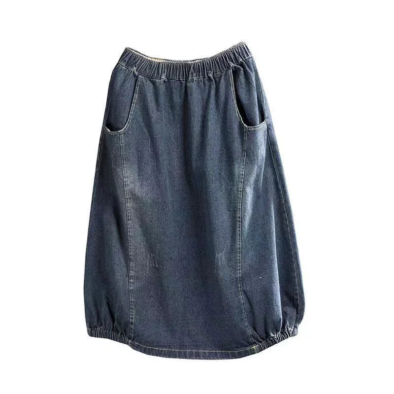 Dark blue denim skirt with elastic waistband, side pockets, and gathered hem