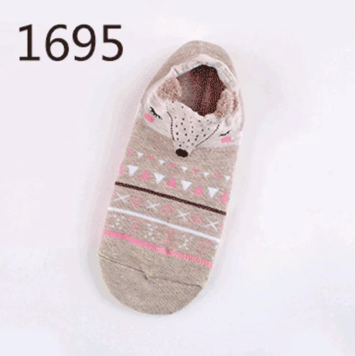 Cozy beige slipper sock with pink and white geometric patterns and a cute fox face design