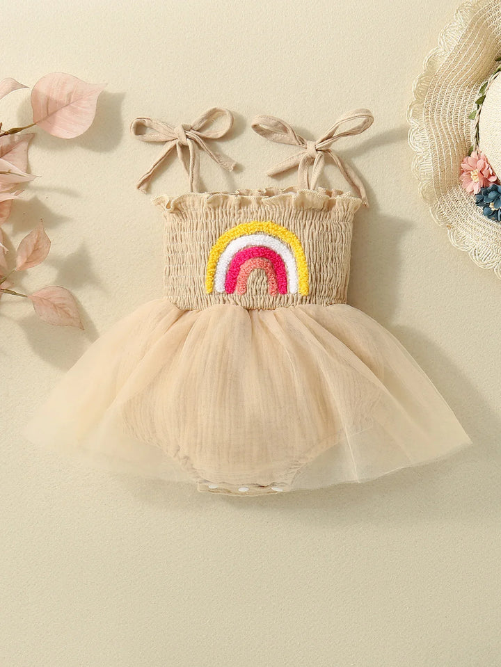 Beige baby girl romper dress with tulle skirt and colorful rainbow embroidery on chest