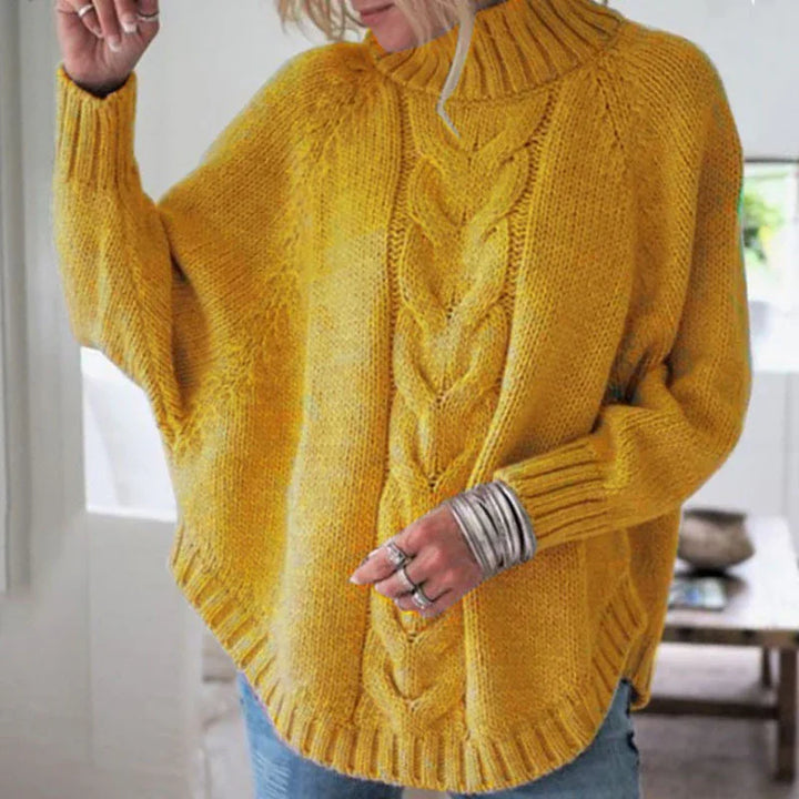 Woman wearing mustard yellow cable knit turtleneck sweater with ribbed cuffs and hem
