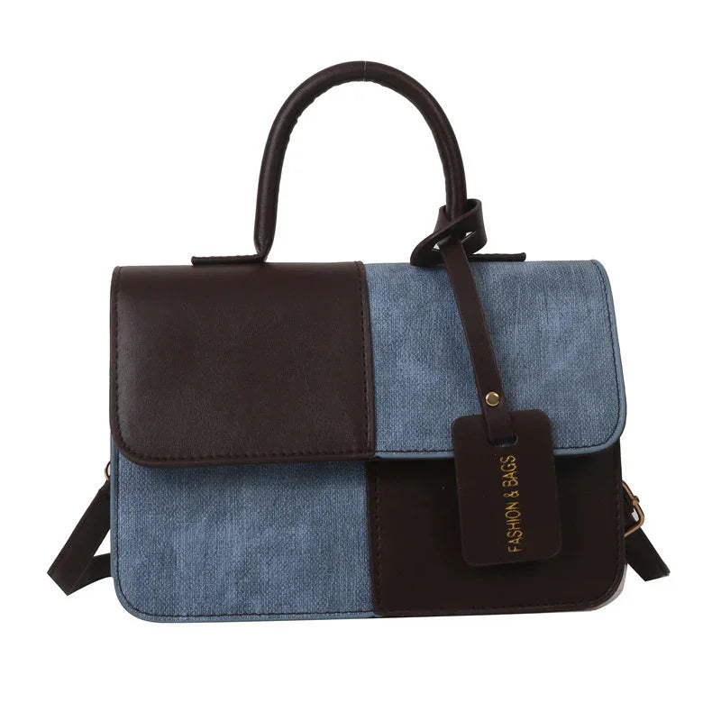 Blue and brown leather patchwork handbag with top handle and fashion tag