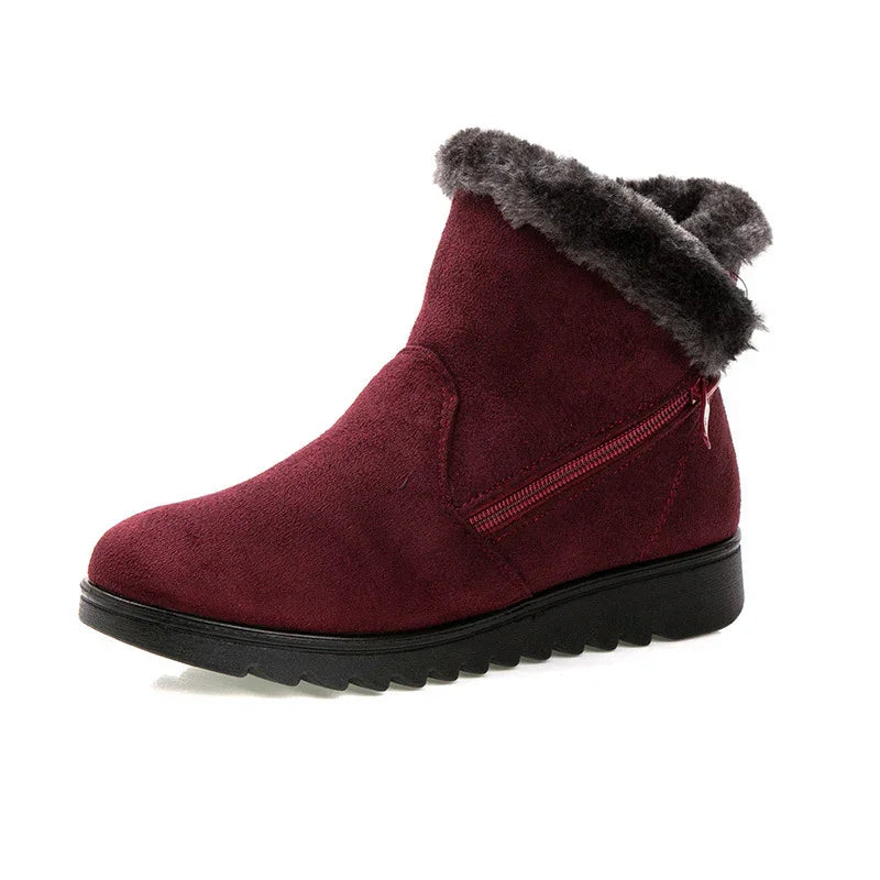 Dark red suede winter ankle boot with black rubber sole and gray faux fur trim