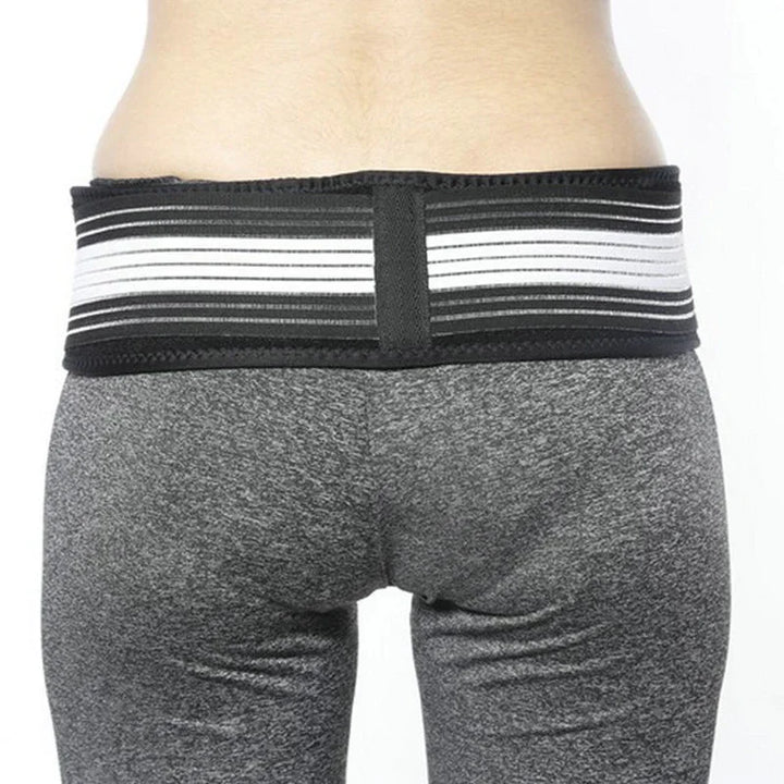 Black and white striped lumbar support belt worn on waist over gray leggings