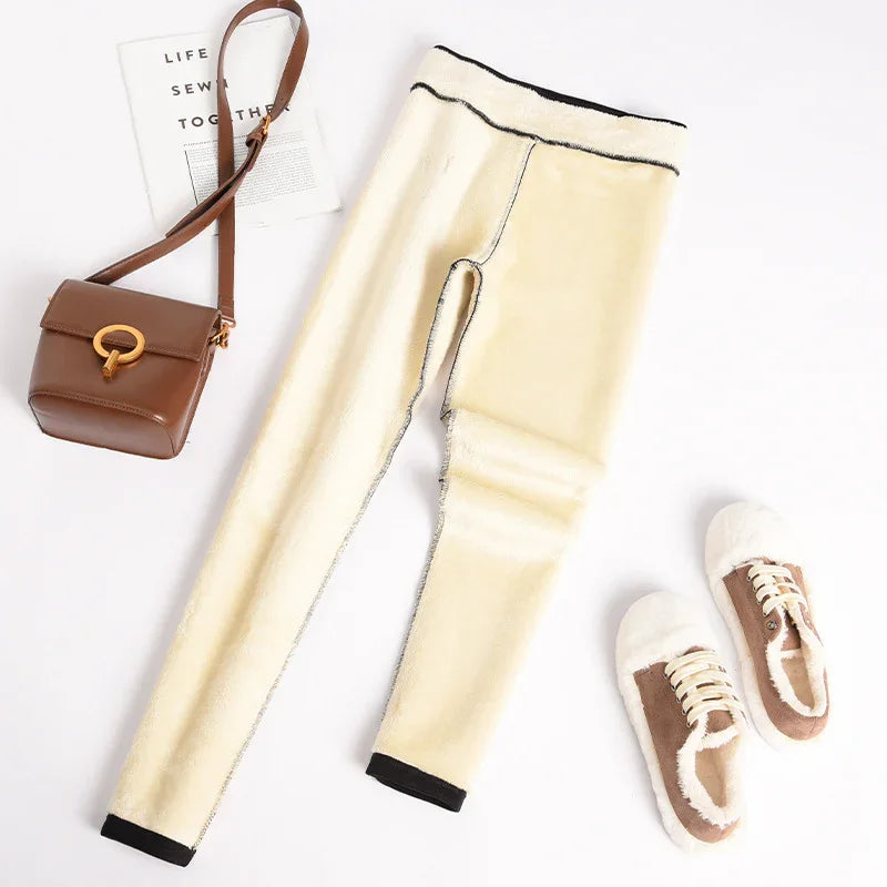 Cream fleece-lined leggings with black trim, brown crossbody bag, and brown fur-lined sneakers on white background