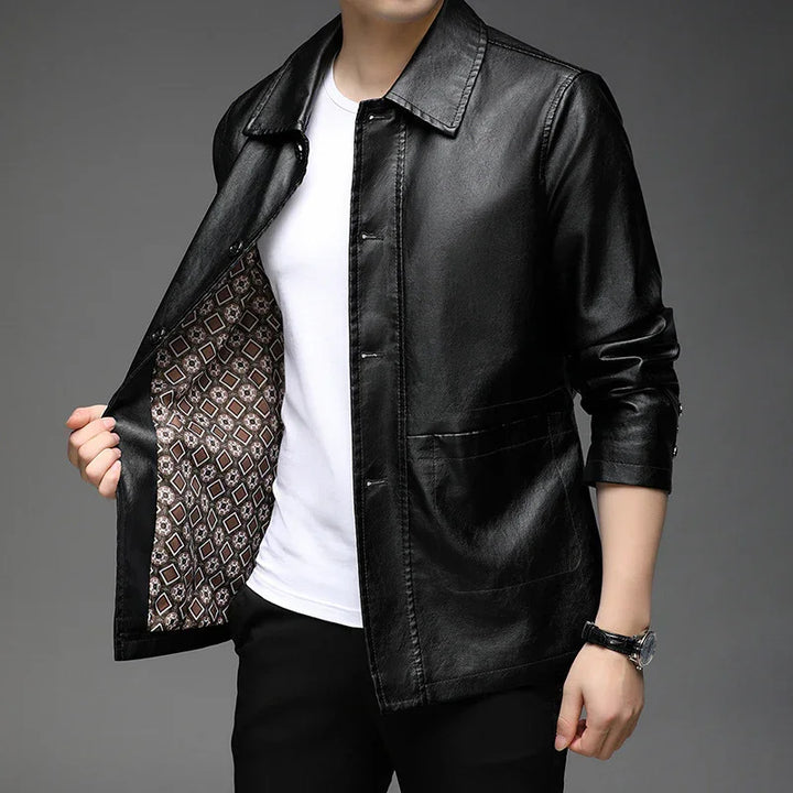 Man wearing sleek black leather jacket with patterned inner lining over white shirt and black pants
