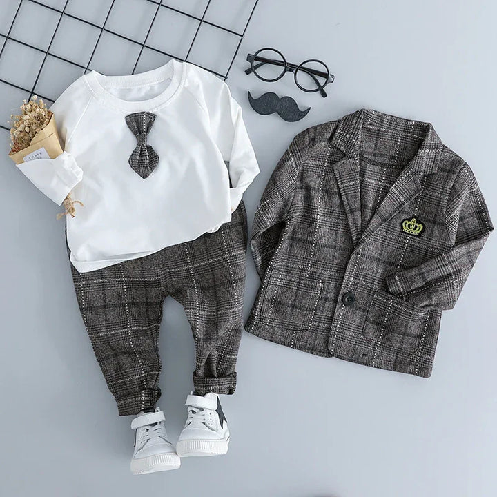 Children's formal outfit with white shirt, plaid pants, matching plaid blazer with crown patch, and white sneakers