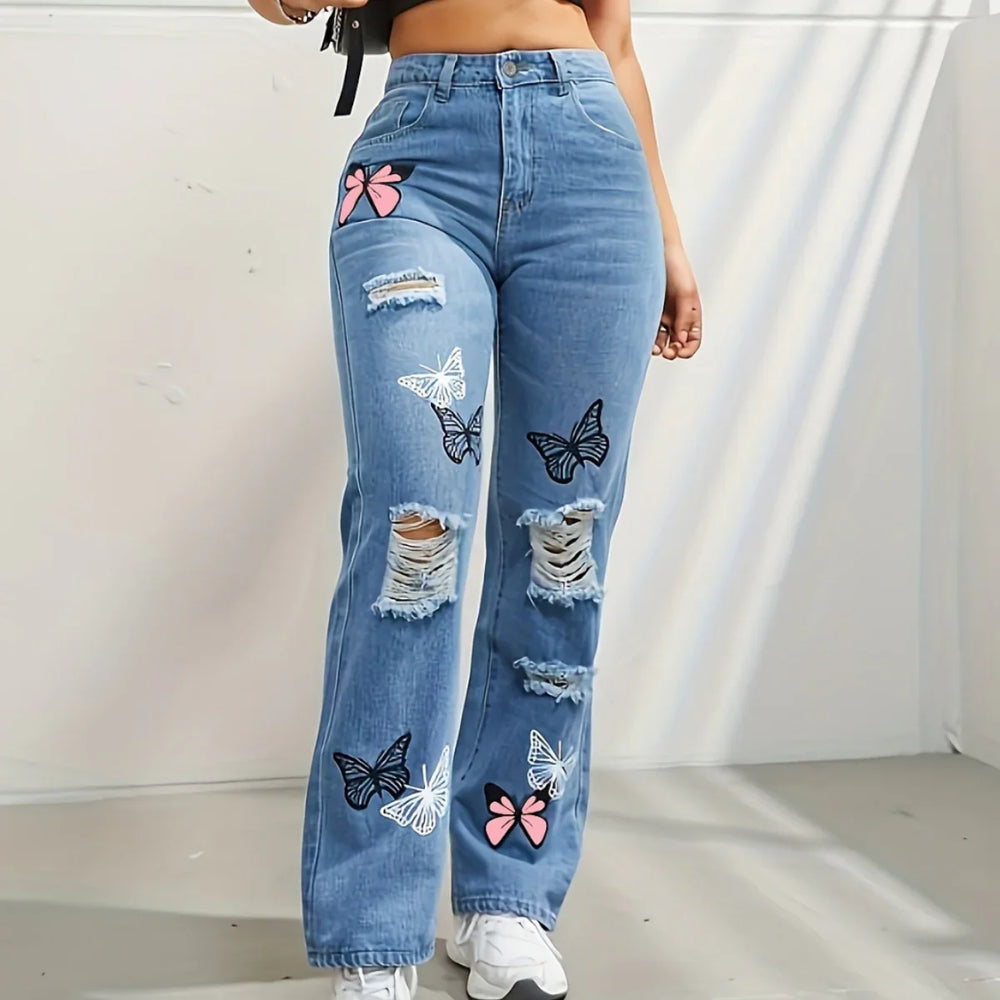 High-waist blue ripped jeans with black, white, and pink butterfly patches worn with white sneakers