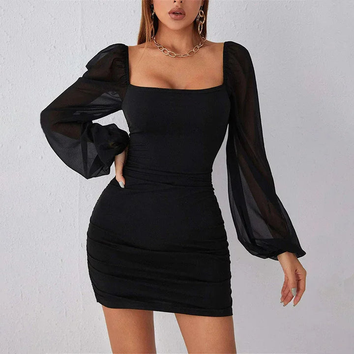 Woman wearing black bodycon mini dress with sheer puff sleeves and square neckline