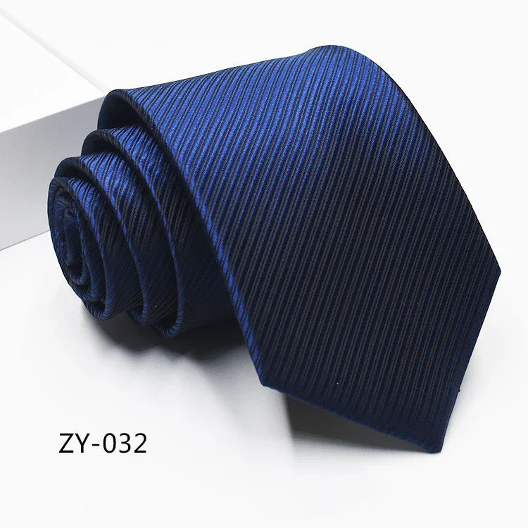 Rolled dark blue striped men's necktie on white surface with code ZY-032