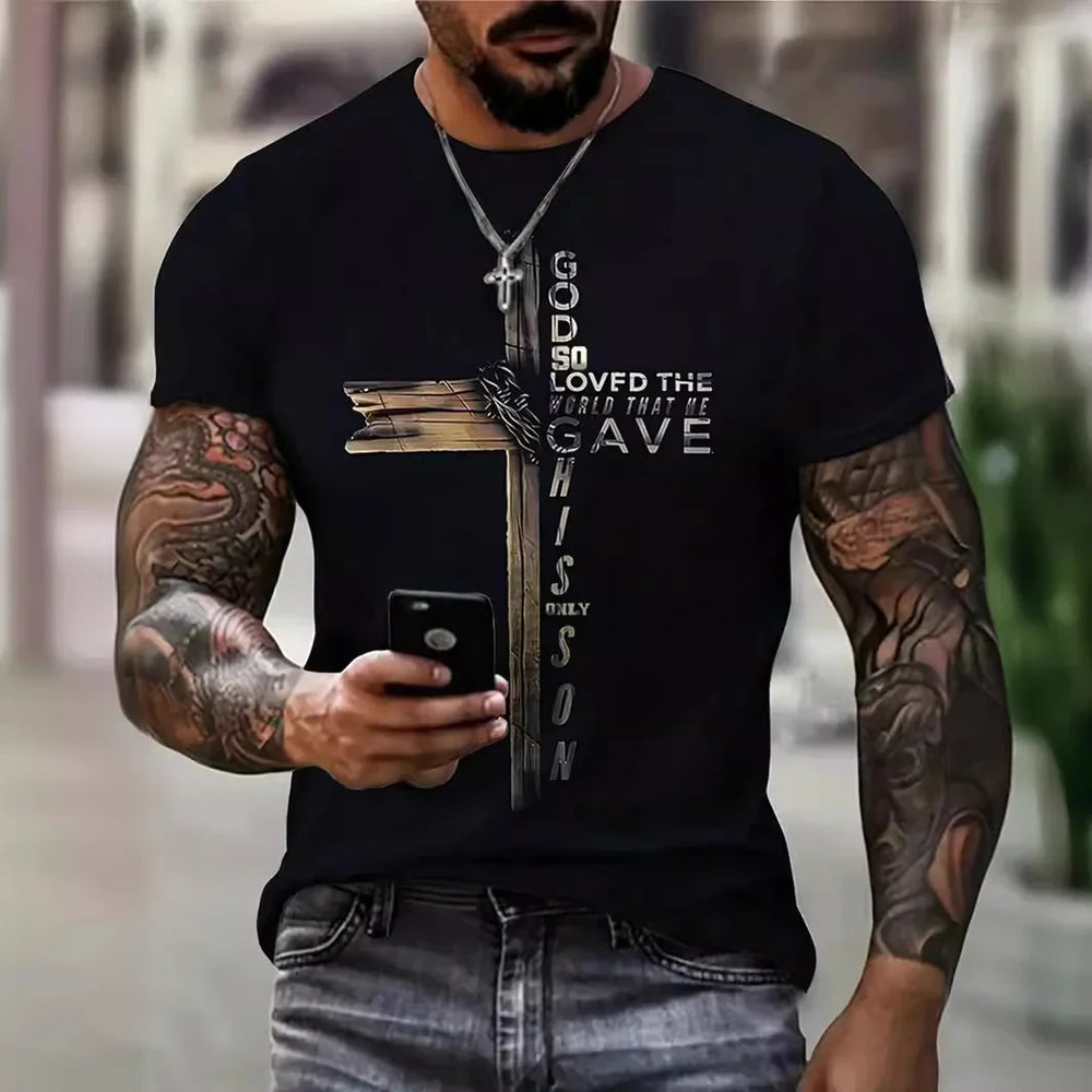Muscular tattooed man wearing black t-shirt with Christian cross and text God so loved the world that he gave