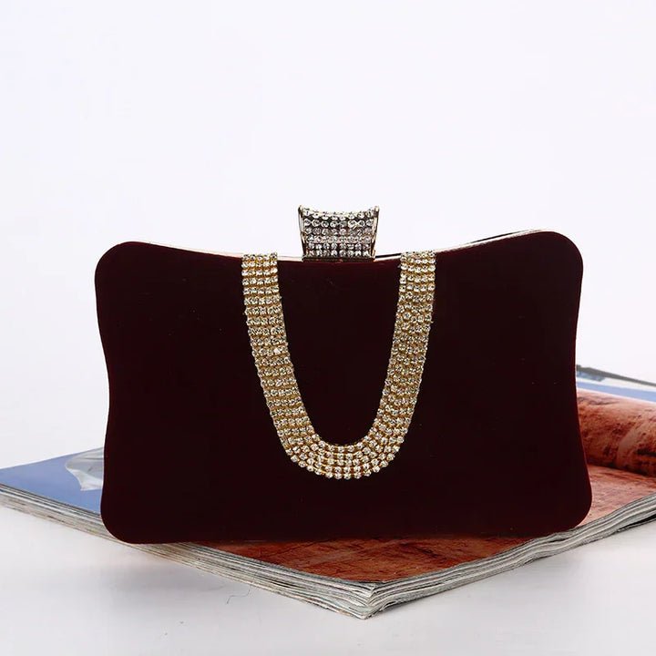 Elegant black velvet clutch purse with gold rhinestone chain detail and jeweled clasp on magazine