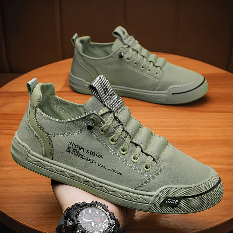 Light green casual sneakers with text detail and lace-up design on wooden table