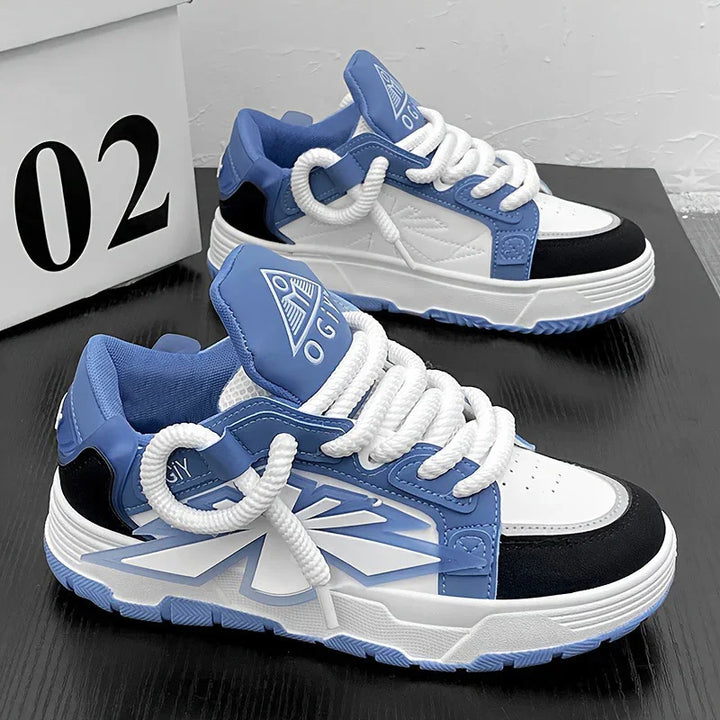 Blue, white, and black casual sneakers with thick white laces on black surface next to white box labeled 02