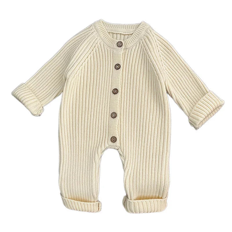 Cream ribbed knit baby onesie with long sleeves and brown buttons front closure