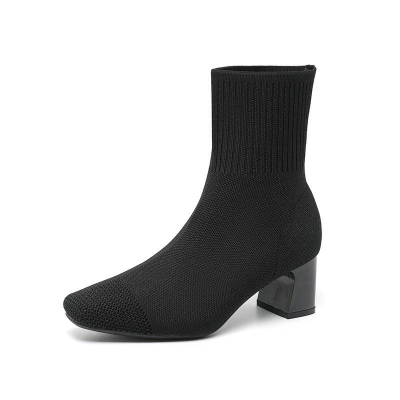 Black knit sock ankle boot with block heel on white background