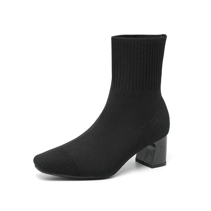 Black knit sock ankle boot with block heel on white background