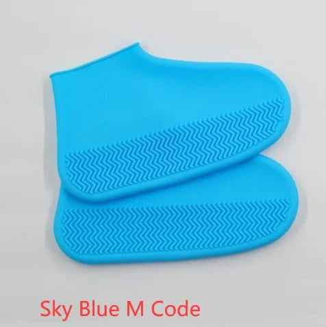 Sky blue silicone shoe covers with textured soles on white background
