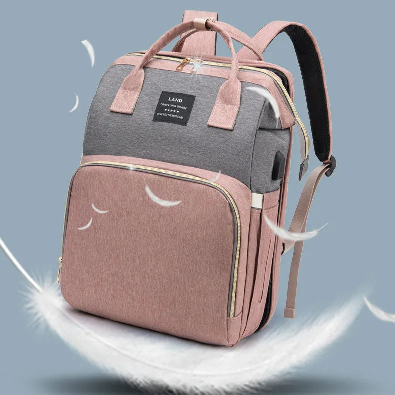 pink and gray lightweight backpack with multiple compartments and dual handles on blue background