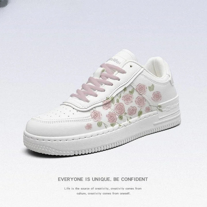 white sneaker with pink rose floral print and light pink laces on a white background