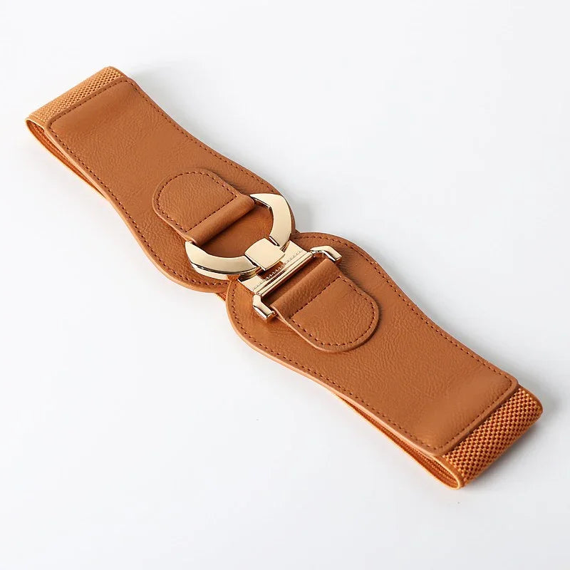 Wide tan faux leather belt with gold metal buckle on white background
