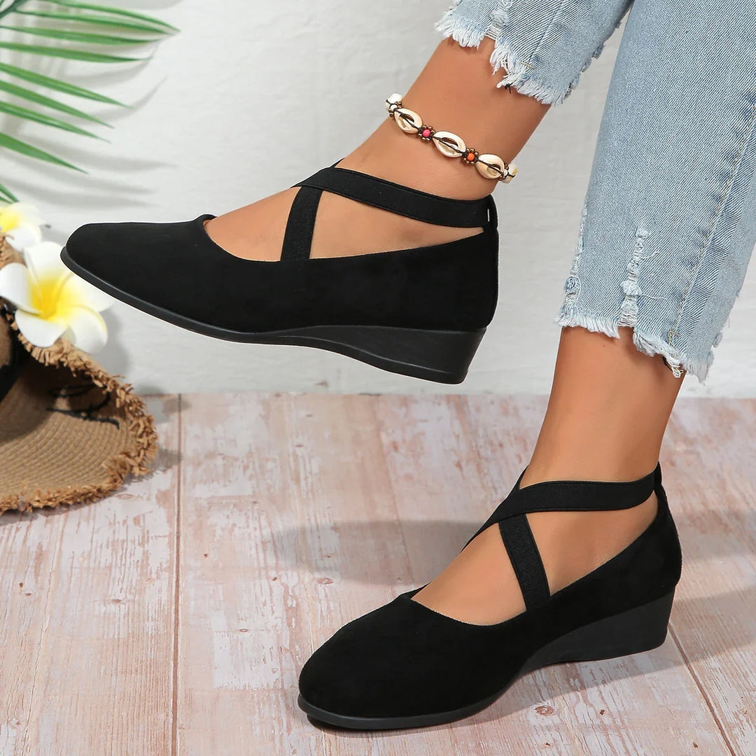 Black wedge shoes with cross straps worn with light ripped jeans and shell anklet