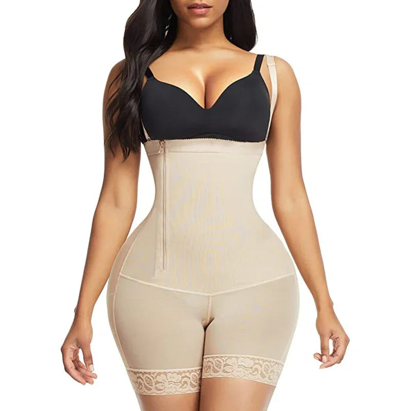 Woman wearing beige waist trainer shapewear shorts with zipper and black bra on white background