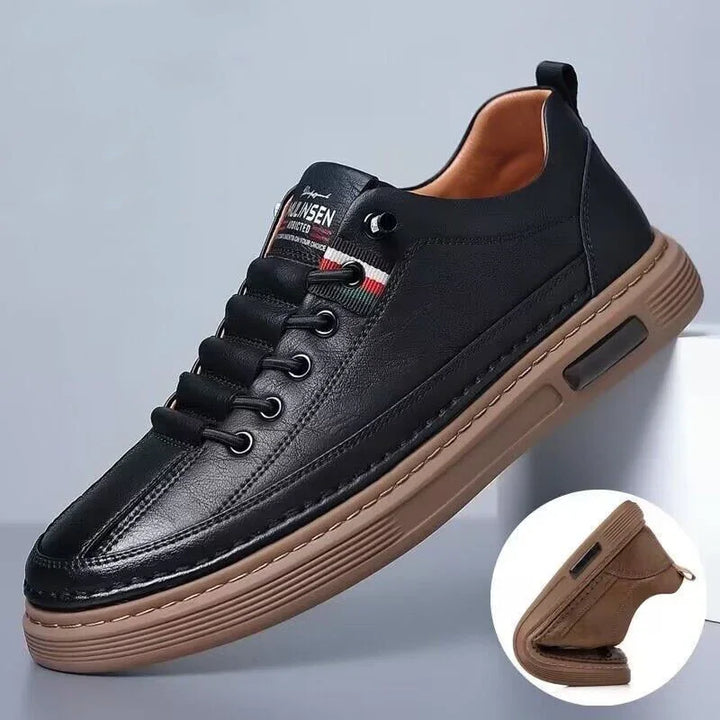 Black leather casual sneaker with brown flexible sole and striped detail near laces