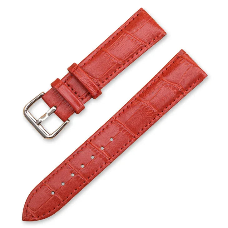 Red leather watch strap with crocodile texture and silver buckle on white background