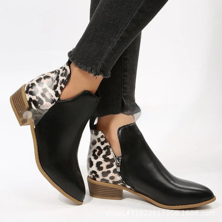 Black leather ankle boots with leopard print heels and wooden low block soles worn with frayed hem black skinny jeans
