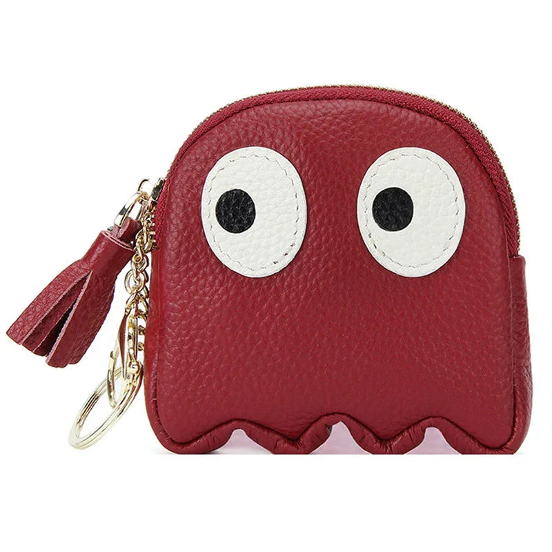 Red leather coin purse with large white eyes, tassel zipper, and gold keychain accessory