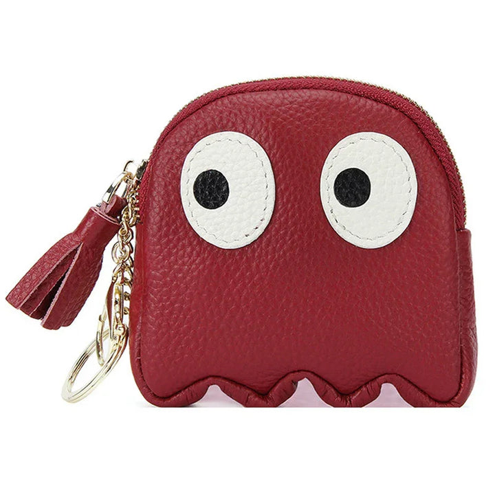 Red leather coin purse with large white eyes, tassel zipper, and gold keychain accessory