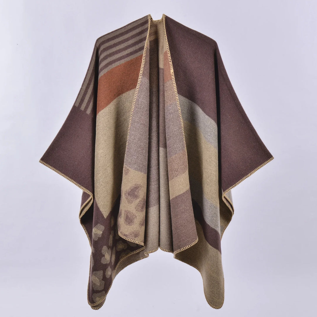 Brown and beige patterned wool poncho with floral and striped design on white background