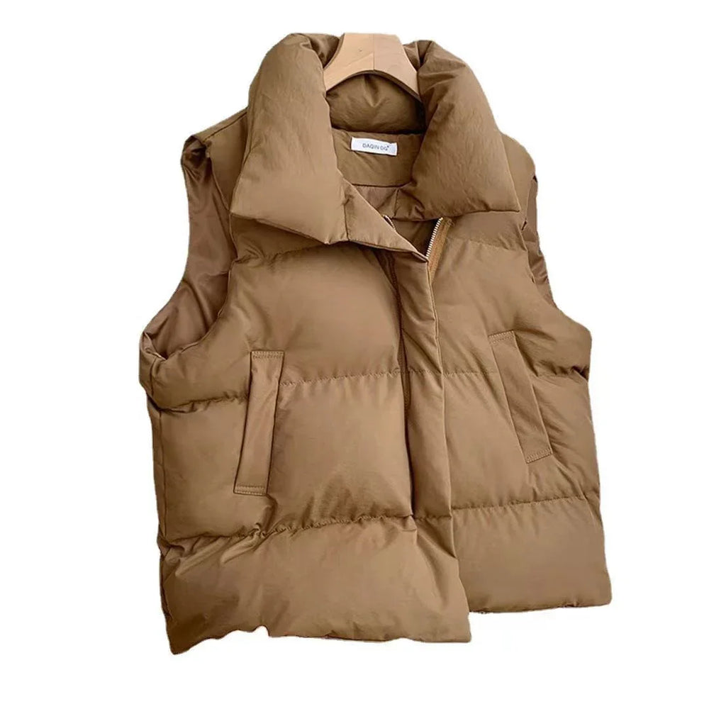 Brown padded sleeveless vest with high collar and front pockets on wooden hanger