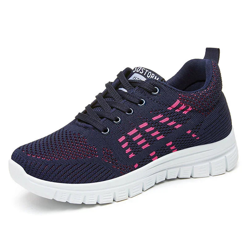 Navy blue and pink knitted athletic sneaker with white flexible sole and black laces
