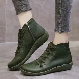 Dark green lace-up ankle boots with side zipper worn with grey frayed hem jeans on tiled floor