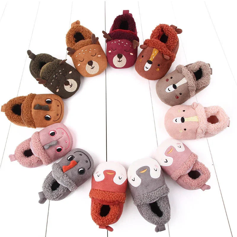 Circle of colorful kids' fuzzy animal slippers on white wooden floor, featuring bears, dogs, birds, and pigs