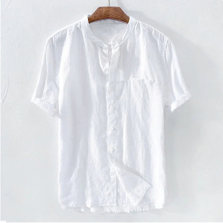 White short-sleeve linen shirt with mandarin collar hanging on wooden hanger