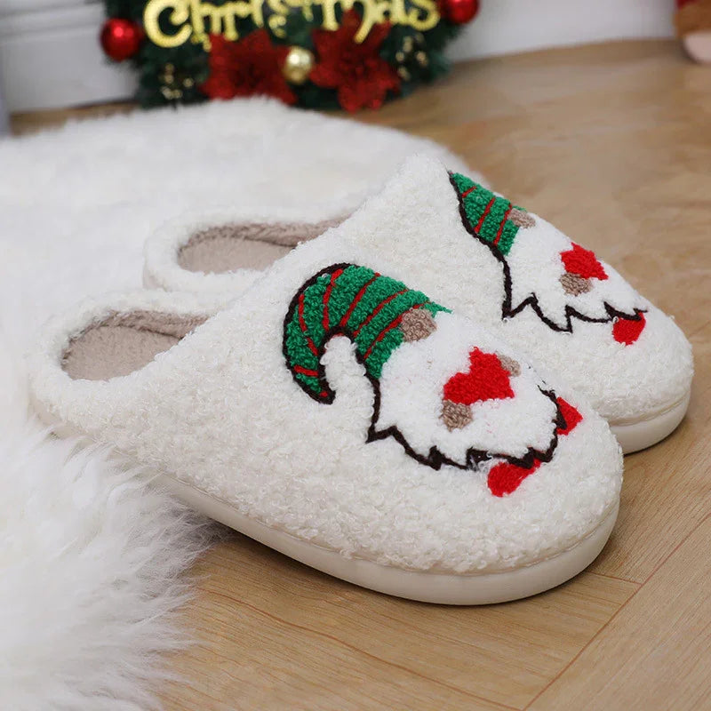White fuzzy Christmas slippers with embroidered gnome wearing green hat, on wooden floor and white rug
