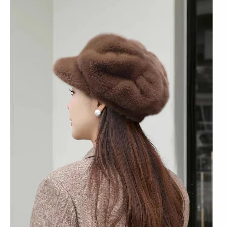 Side view of woman wearing brown fuzzy beret and pearl earrings with long brown hair and brown coat