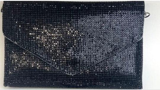 Black sequined envelope clutch bag with rectangular shape and flap closure