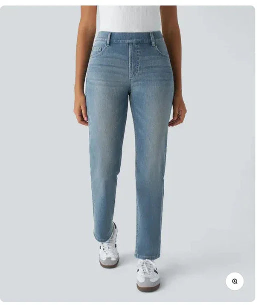 woman wearing light blue high-waisted straight leg jeans with white sneakers and white top