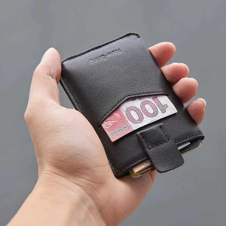 Hand holding a black leather wallet with a 100 Hong Kong dollar bill visible in the outer pocket