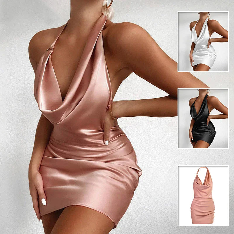 Woman wearing satin cowl neck halter mini dress in blush pink, with additional white and black color options