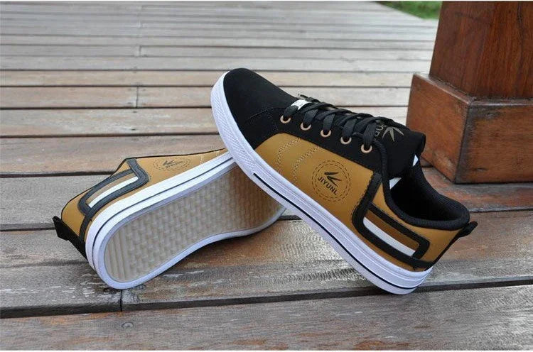 Casual brown and black Vintune sneakers with white soles displayed on wooden floor