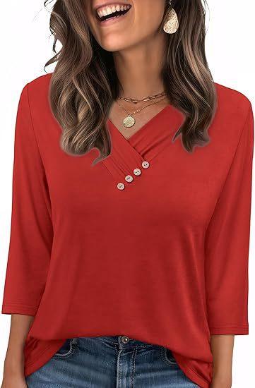 Woman wearing red 3/4 sleeve blouse with button detail, layered gold necklaces, and earrings