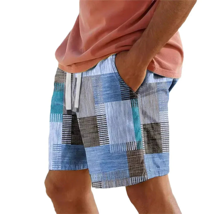 Men's casual shorts with blue, gray, and teal patchwork pattern and white drawstring