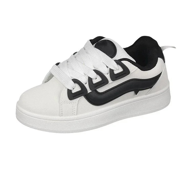 White sneaker with thick sole, black curved design on side, white laces, and black interior lining