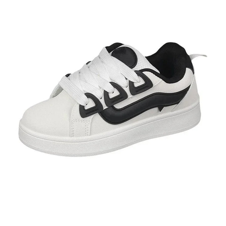 White sneaker with thick sole, black curved design on side, white laces, and black interior lining
