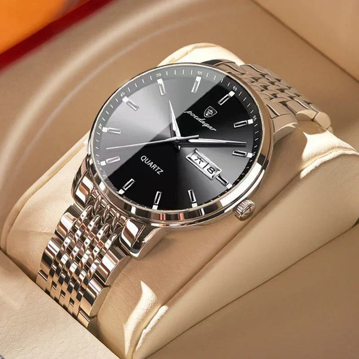 Silver stainless steel quartz wristwatch with black dial and date display on beige cushion